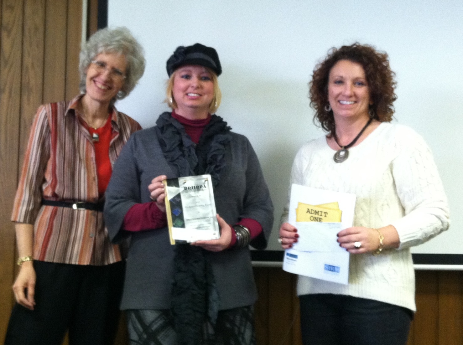 Carol Fitzgerald, Diversity Chair, presents the award to Ashley Houck and Lisa Taylor.